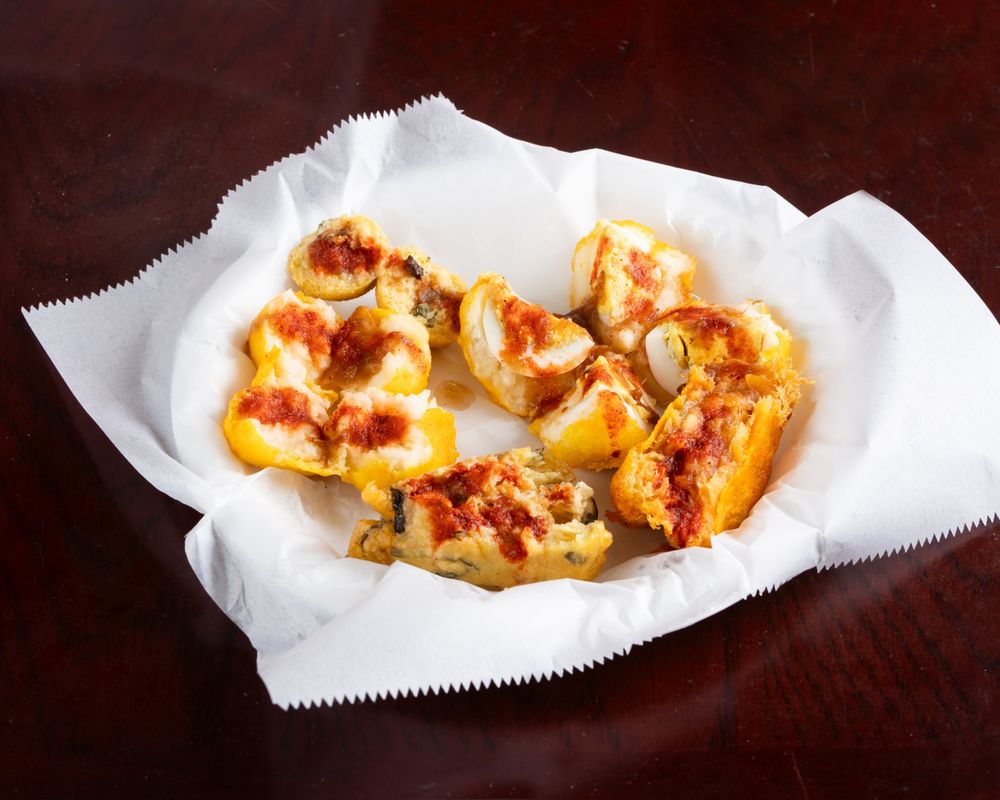 Egg balls and fried snacks with sauce